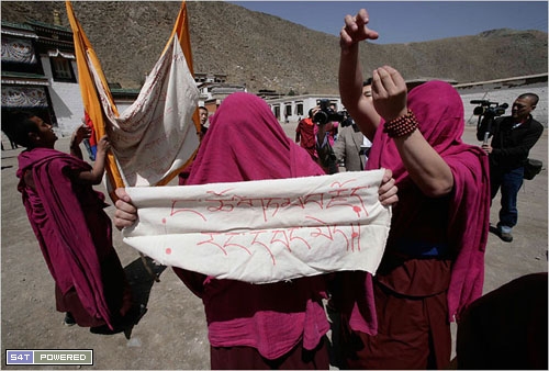 Monks with covered faces protesting Chinese involvement in Tibet