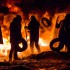 Protestors throwing tires in the fire.